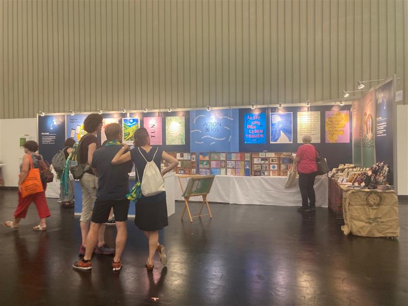 Der diesjährige Stand mit blauem Hintergrund war ein absoluter Hingucker im grauen Messegebäude – Kaffee, Kalender, Karten und vieles mehr wurden von Messebesucher:innen interessiert aufgenommen.